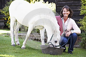 Farmer's Wife Feeding Pony