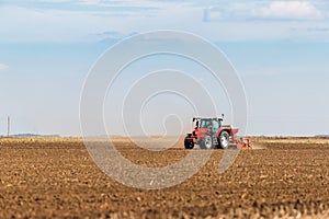 Farmer seeding, sowing crops at field.