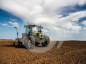 Farmer seeding, sowing crops at field.