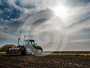 Farmer seeding, sowing crops at field.