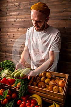 Farmer selling organic veg at market. Rustic style.Healthy food concept