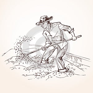 Farmer with a shovel raises grain.