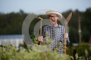 Farmer with shovel and rake screaming at the farm work