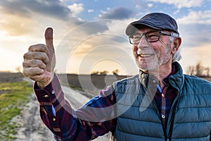 Farmer showing thumb up in field