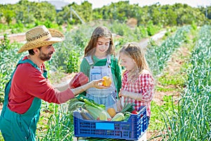 Farmer showing vegetables harvest to kid girls