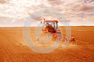 Farmer sowing crops at field photo