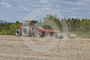 Farmer sowing seeds with agricultural seeder.