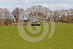 Farmer spraying field