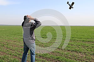 A farmer standing on his wheat field sees a small plane overhead about to crash