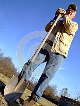 Farmer Standing with Shovel