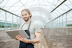 Farmer with tablet in the glasshouse