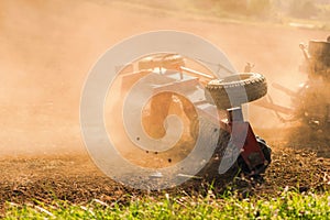 Farmer tractor with disc harrow system working on a stubble field