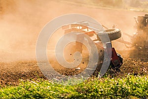 Farmer tractor with disc harrow system working on a stubble field