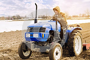 Farmer on a tractor with milling machine loosens, grinds and mixes soil. Loosening the surface, cultivating the land for further