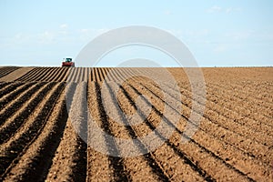 A farmer planting potatoes in an Idaho farm field.