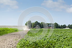 Farmer with tractor and plow in field