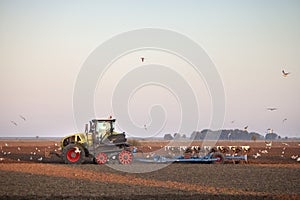 Farmer with tractor plows field in late summer on countryside of lower saxony in germany
