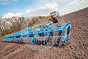 Farmer in tractor preparing farmland the next year