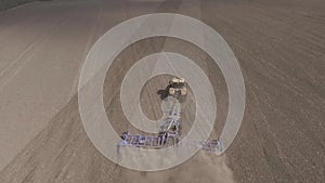 Farmer in tractor preparing farmland with seedbed for the next year