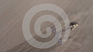 Farmer in tractor preparing farmland with seedbed for the next year