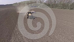 Farmer in tractor preparing farmland with seedbed for the next year