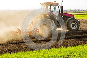 Farmer in tractor preparing land with seedbed cultivator