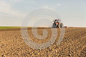 Farmer in tractor preparing land with seedbed cultivator