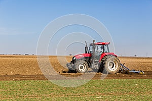 Farmer in tractor preparing land with seedbed cultivator