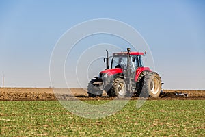 Farmer in tractor preparing land with seedbed cultivator