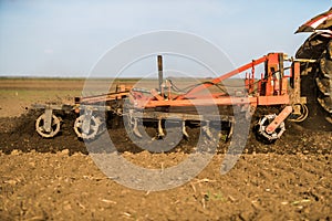 Farmer in tractor preparing land with seedbed cultivator