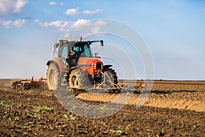 Farmer in tractor preparing land with seedbed cultivator