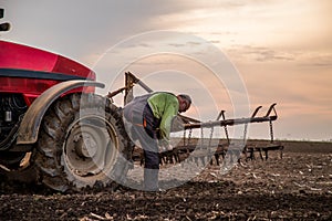 Farmer in tractor preparing land with seedbed cultivator