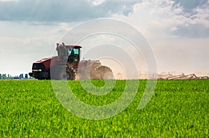 Farmer in tractor preparing land with seedbed cultivator