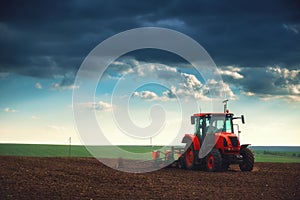 Farmer in tractor preparing land with seedbed cultivator