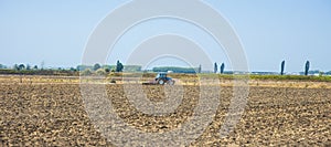 Farmer in tractor preparing land with seedbed cultivator