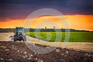 Farmer in tractor preparing land with seedbed cultivator