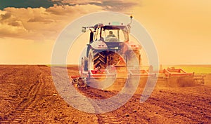 Farmer in tractor preparing land for sowing