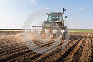 Farmer with tractor seeding - sowing soy crops at agricultural f