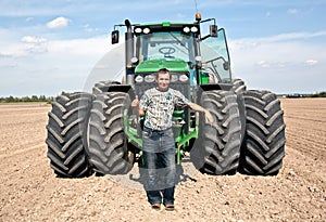 Farmer with tractor showing OK gesture