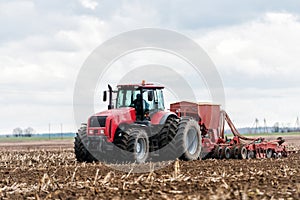 Farmer tractor working in the field. Spring time for sowing.