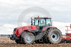 Farmer tractor working in the field. Spring time for sowing.