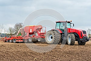 Farmer tractor working in the field. Spring time for sowing.