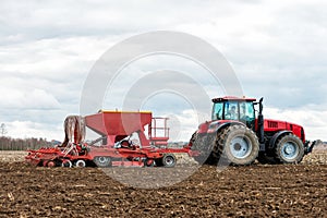 Farmer tractor working in the field. Spring time for sowing.