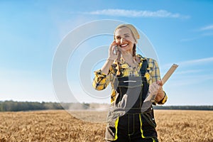 Farmer using her phone on a grain field