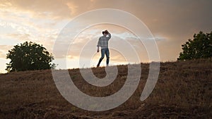 Farmer walking down the wheat field in sunset