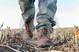 farmer walking in field wearing sturdy brown work boots