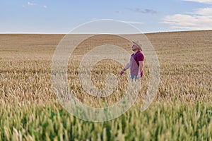 Farmer walking through a wheat field