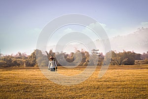 Farmer walking after work in a wheat field