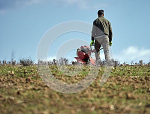 Farmer weeding the field with a tiller