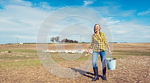 Farmer woman feeding the geese